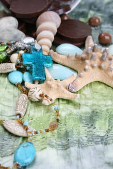 Chocolates, Seashells and jewellery on a seagreen cloth