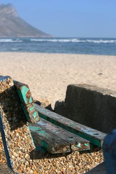 Old worn bench near the sea. FOCUS on the seat