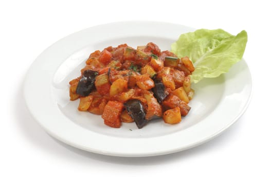 A vegetarian hotchpotch on a plate on white background
