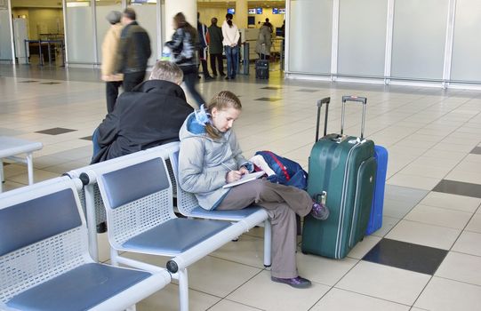 Girl keeps a record journeys in airport