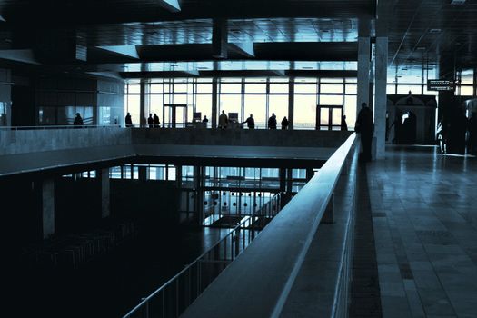 People silhouettes at airport building 
