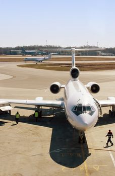 Truck refueling an airplane on the airport