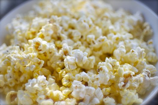 A bowl is full of yummy popcorn.