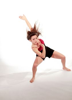 Young pretty teenage girl brunette Dancing in studio with long hair