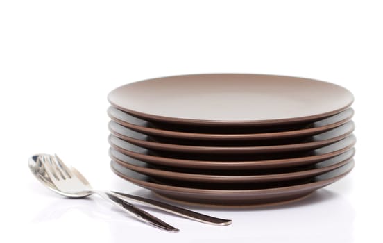 A stack of plates with fork and spoon