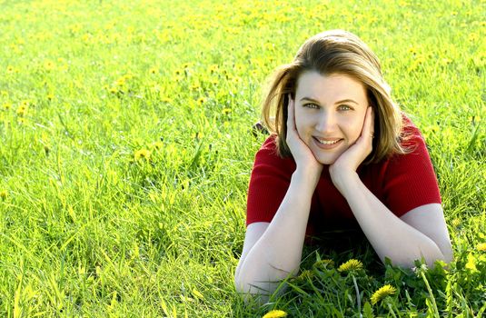 Woman in red jacket on summer's meadow.