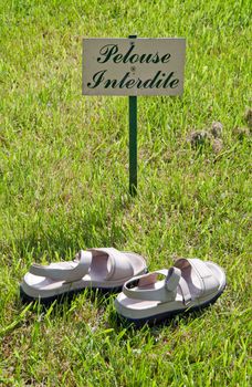 prohibited lawn: pair of shoes on the lawn, a sign of disobedience