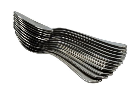 A Pile of stainless steel Spoons facing at an angle and spread out