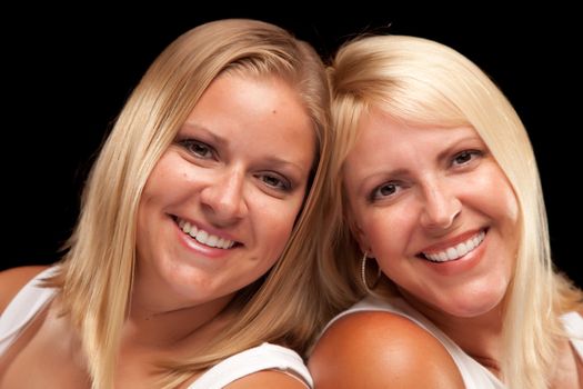 Two Beautiful Smiling Sisters Portrait Isolated on a Black Background.