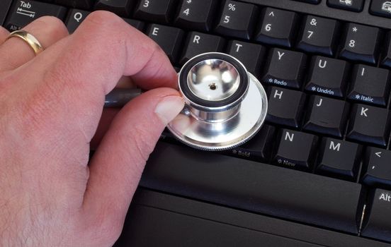 Man Holding Stethoscope on Keyboard Diagnosing the Issue
