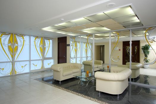 Lobby of hotel with sofas and a mirror