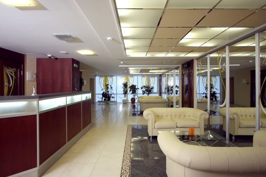 Lobby of hotel with sofas and a mirror