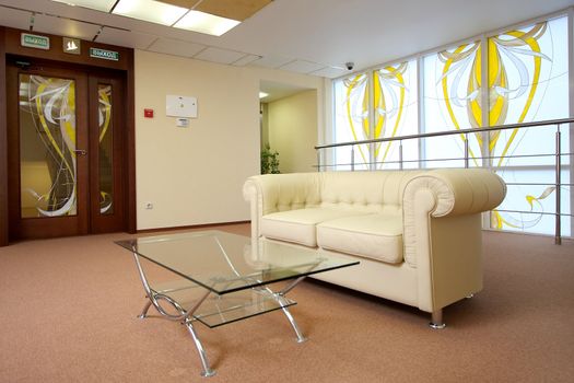 Lobby of hotel with sofas and a mirror