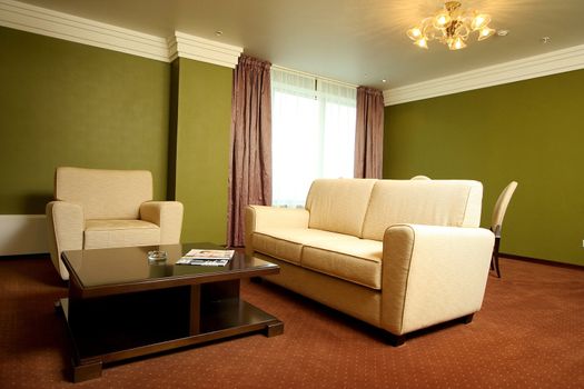 Magnificent hall with a sofa armchairs and windows