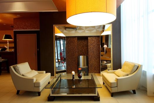 Lobby of hotel with sofas and a mirror