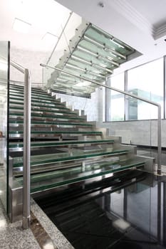 The big ladder from glass in a hall of office building