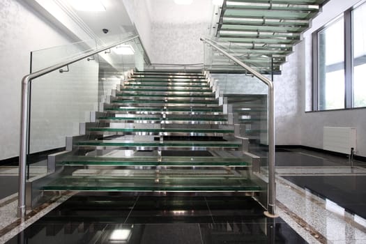 The big ladder from glass in a hall of office building