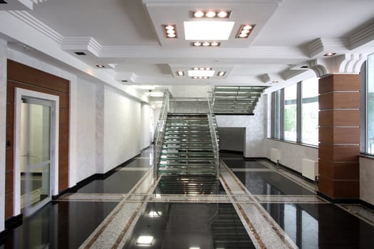 The big ladder from glass in a hall of office building