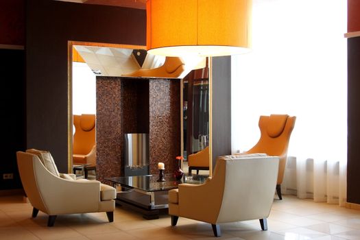 Lobby of hotel with sofas and a mirror