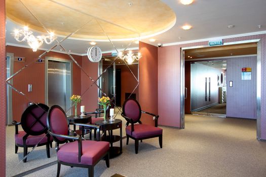 Lobby of hotel with sofas and a mirror