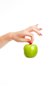 Woman hand holding a bright green apple by it's stalk