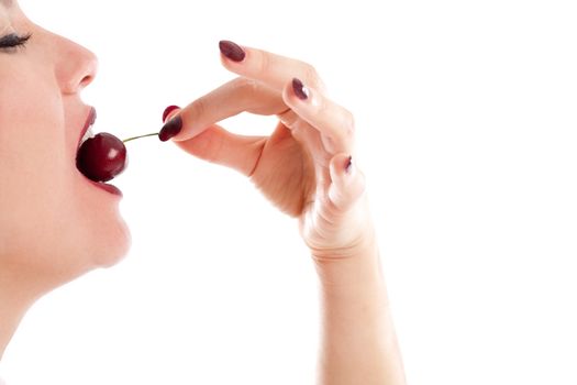 Woman eating a cherry on white background
