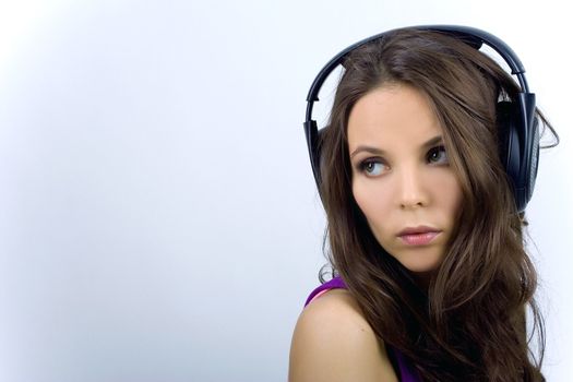 Young dj girl in club clothes with headphones