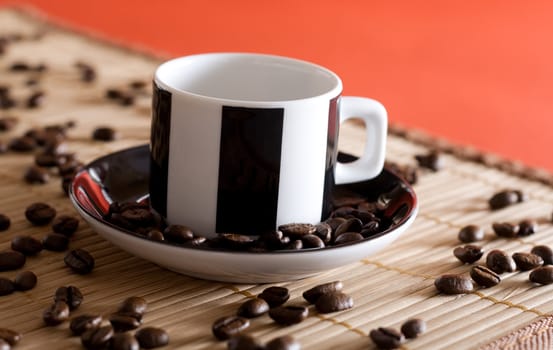 A espresso cup with coffee beans as decoration