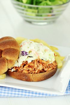 Slaw burger with whole wheat buns, fries and salad.