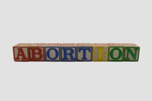 Vintage Wood Alphabet blocks spelling abortion