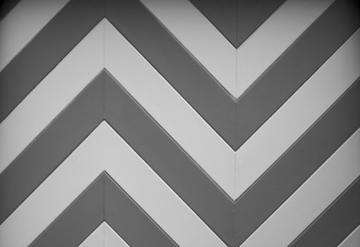 a black and white chevron or zig zag wood design of a garage door on an older home