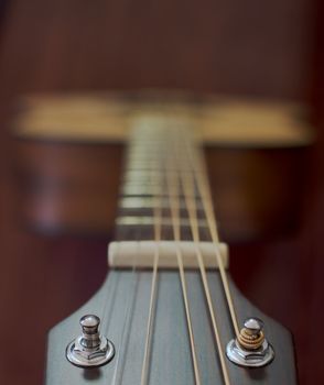 Guitar neck and strings looking from the head towards the body