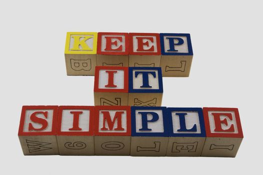 Wood Alphabet blocks spelling KIS Keep it simple 