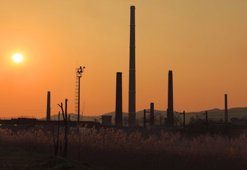 Image of industrial silhouettes at sunset.