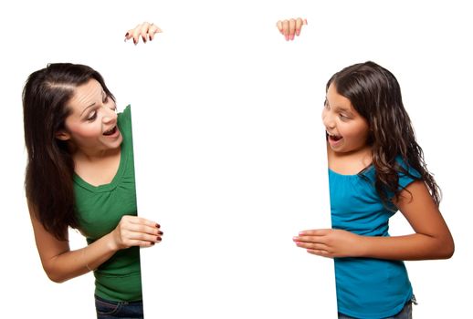 Pretty Hispanic Girl and Mother Holding Blank Board Isolated on a White Background.