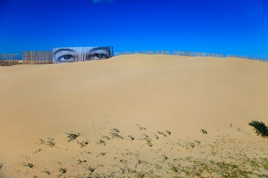 Superposed eyes on the boards of a dune of Cortadura's beach ( Cádiz )