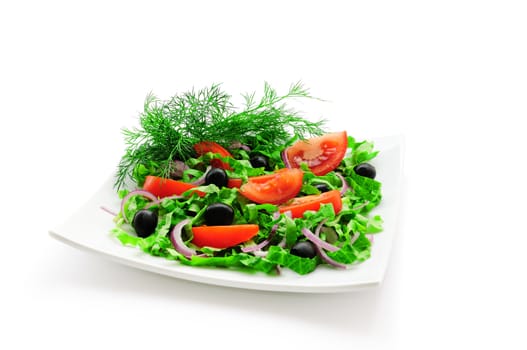 Vegetable salad (tomato, lettuce, olives) with greens