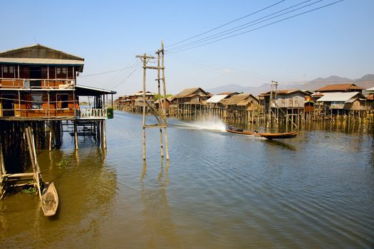 Village house on Inle lake standing on stilt and made from bamboo and palm leafs is accessible only via small boat.