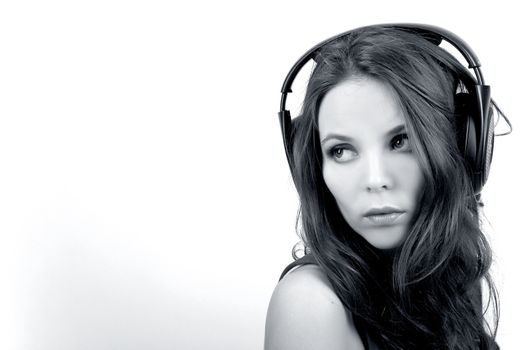 Young dj girl with headphones on white background in monochrome