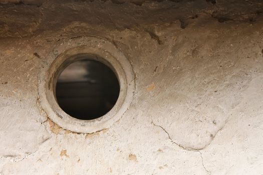 Ventilation hole in the wall of the old barn