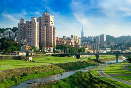 Here is a cityscape of apartment with blue sky.