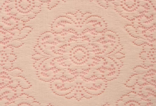 beige lace doily on pink useful for a background