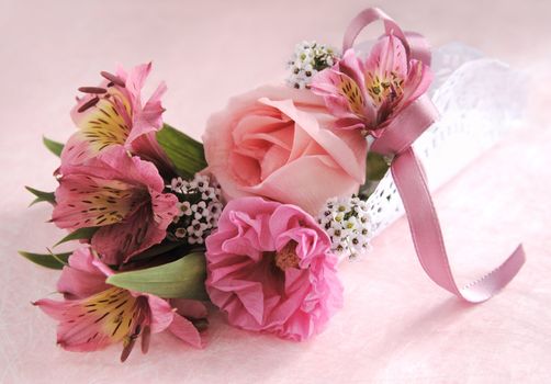 rose, hibiscus and alstroemeria wrapped in a doily