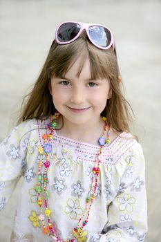 Beautiful little girl portrait outdoors in the city