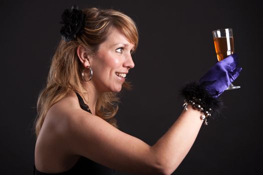 Pretty blond woman raising her glass in a toast