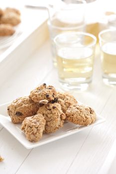 Delicious and freshly baked oatmeal raisin cookies with tea