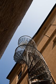 A fire escape, narrow round staircase