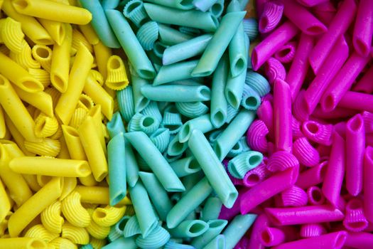 Colorful pasta food in three colors, yellow, blue and pink