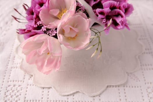 tulips, pelargoniums and breath of heaven flowers on textured linens