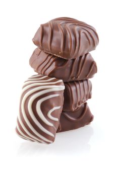 Pile of sweet belgian chocolated, isolated on white.